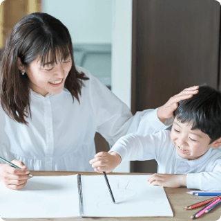 mother helping a child write