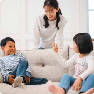 mother talking to boy and girl on the couch